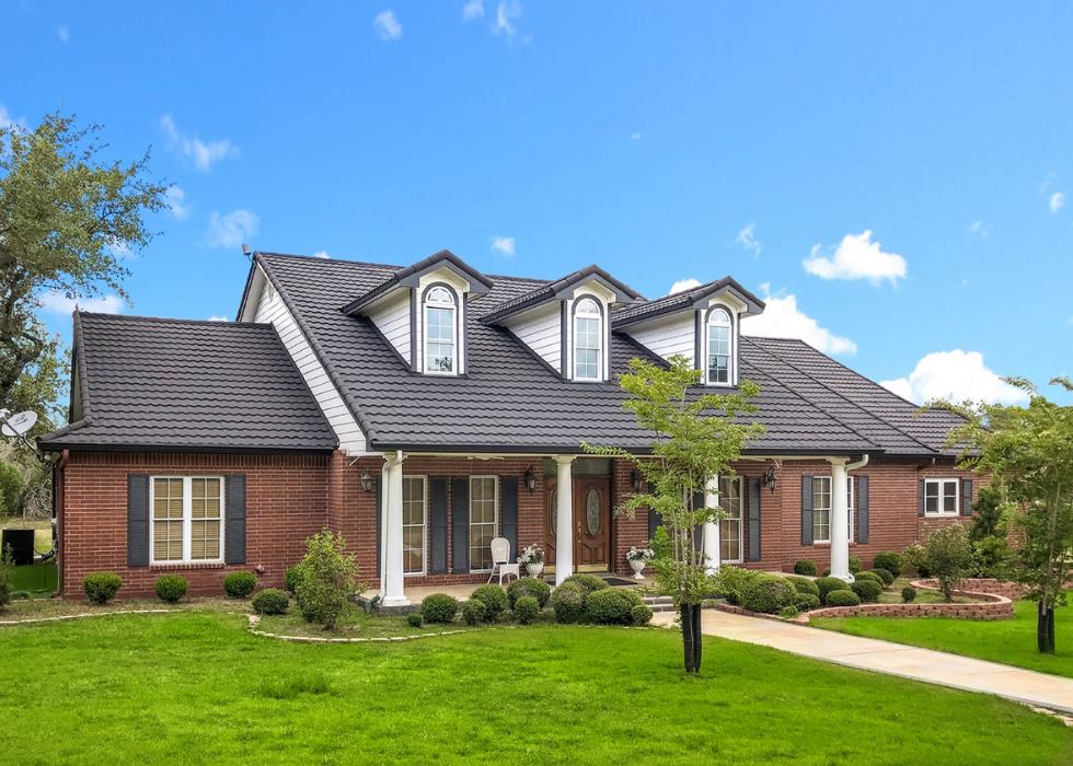 contemporary-charcoal-gray-roof-tiles Modern dark roof tiles installed on a hip roof in Orlando, FL
