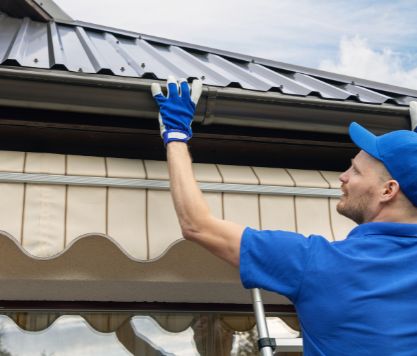 SunVena Roofing contractor repairing metal seam on tin roof in Orlando, FL