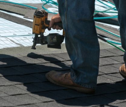 Roofer replacing blown away shingles in Lakeland, FL